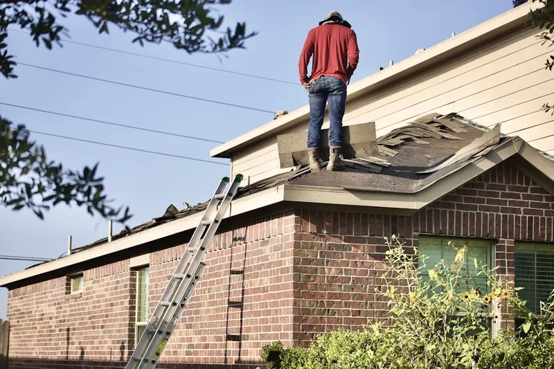 Professional roofer working on a residential roof in Walters Ferry